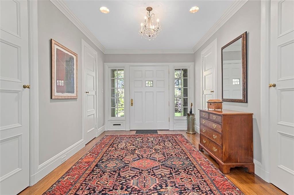 1342 Inverness Avenue Pittsburgh, PA 15217 - Photo 3 of 40 a hallway with a dresser with wooden floor