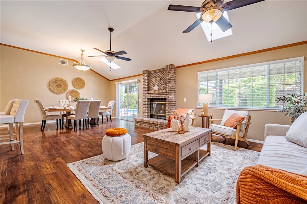 625 Redwing Drive Merced, CA 95340 - Photo 23 of 57 a living room with furniture a fireplace and a chandelier