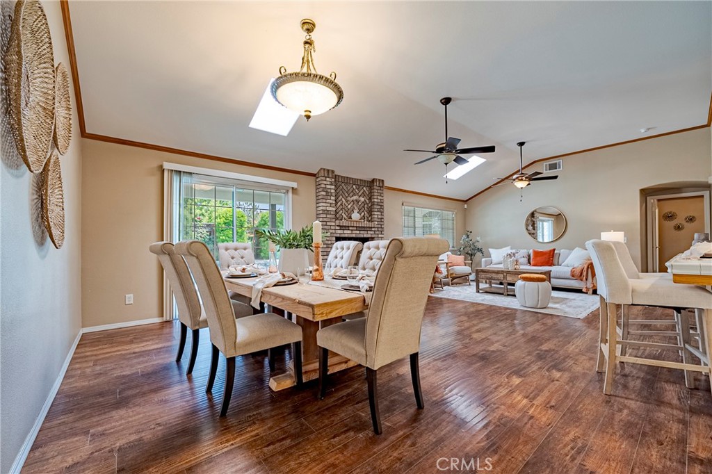 625 Redwing Drive Merced, CA 95340 - Photo 25 of 57 a dining room with wooden floor a chandelier a wooden table and chairs