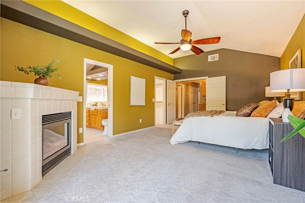 625 Redwing Drive Merced, CA 95340 - Photo 36 of 57 a spacious bedroom with a bed and a chandelier