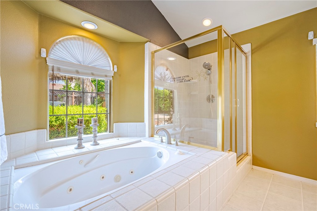 625 Redwing Drive Merced, CA 95340 - Photo 38 of 57 a bathroom with a tub sink and mirror