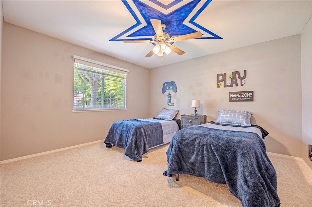 625 Redwing Drive Merced, CA 95340 - Photo 41 of 57 a bedroom with two beds and a chandelier