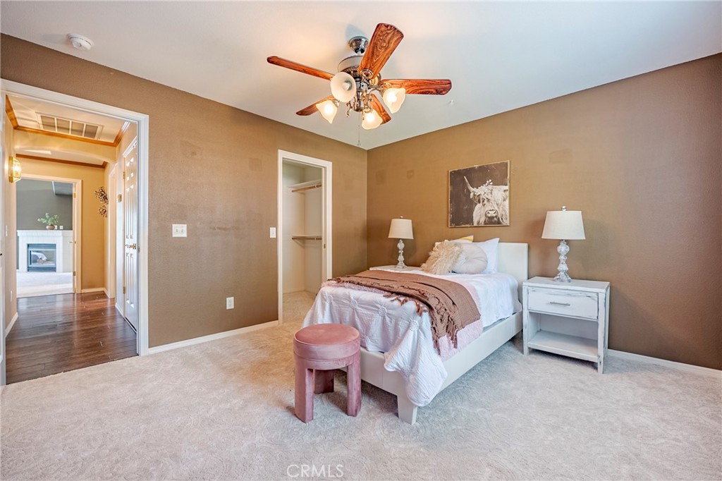 625 Redwing Drive Merced, CA 95340 - Photo 43 of 57 a spacious bedroom with a bed and a chandelier