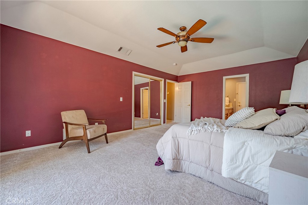 625 Redwing Drive Merced, CA 95340 - Photo 47 of 57 a bedroom with a bed and a chandelier
