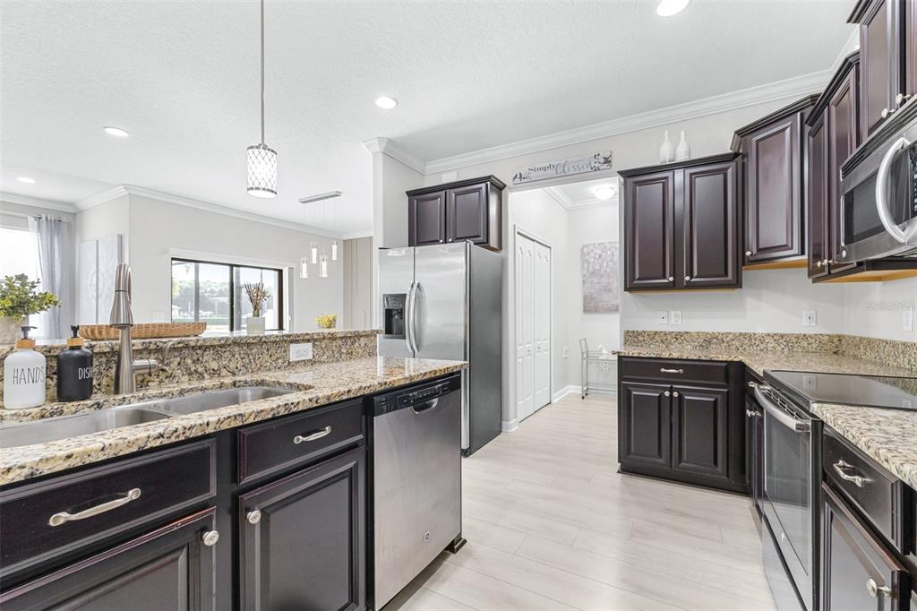1762 Hadden Hall Place Trinity, FL 34655 - Photo 12 of 49 a kitchen with stainless steel appliances granite countertop a sink stove and refrigerator