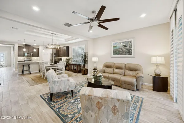 a living room with furniture and kitchen view