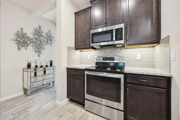 a kitchen with a stove and a microwave