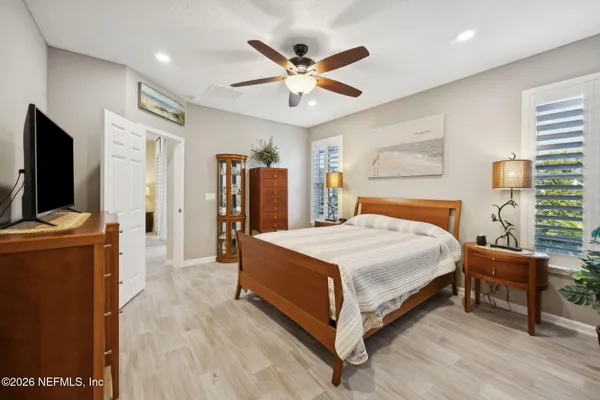 a bedroom with a bed and a flat screen television