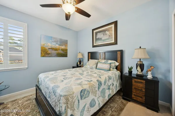 a bedroom with bed and window