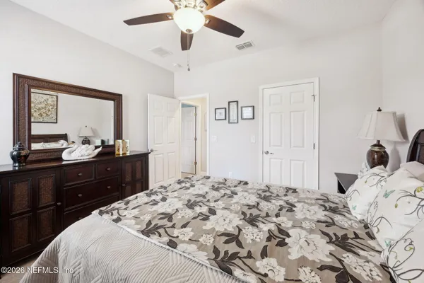 a bedroom with a bed and a dresser