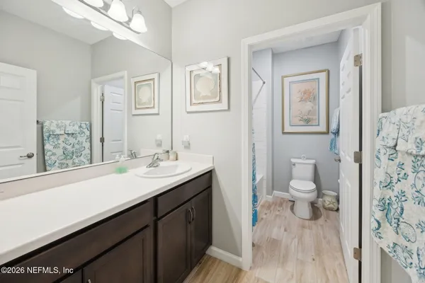 a bathroom with a sink a toilet and a mirror