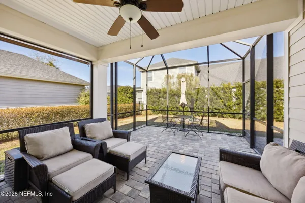 a living room with furniture and a floor to ceiling window
