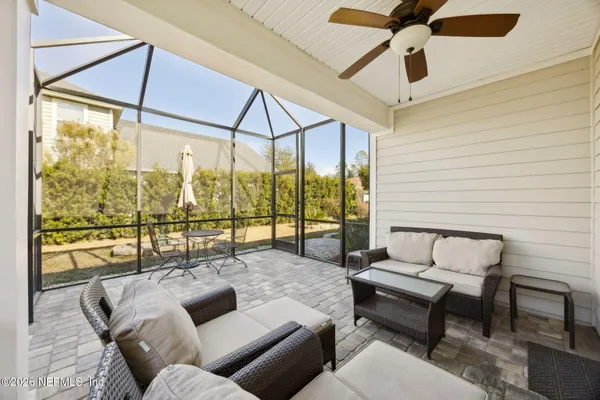 a living room with furniture and a floor to ceiling window