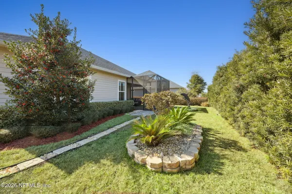 a view of a garden with a house