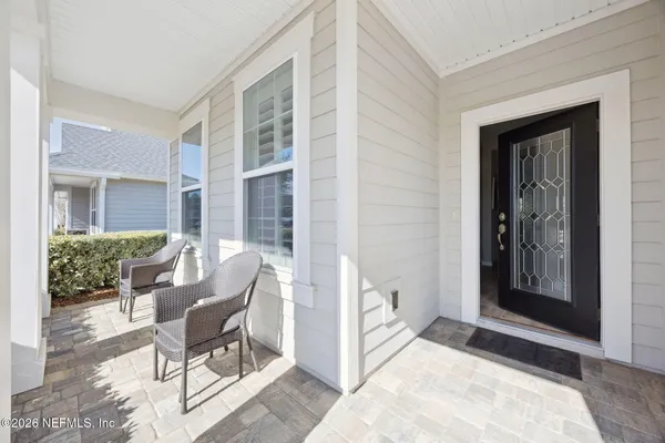 a view of a front door and dining room