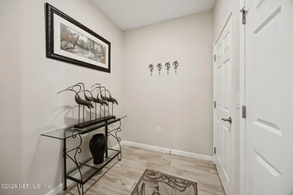 a view of an entryway with wooden floor