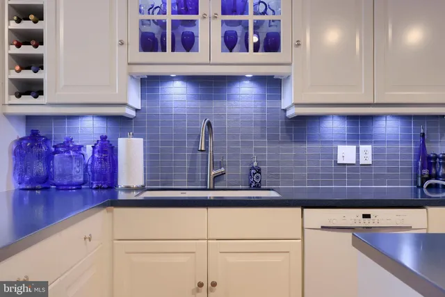 a kitchen with stainless steel appliances kitchen island granite countertop cabinets and wooden floor