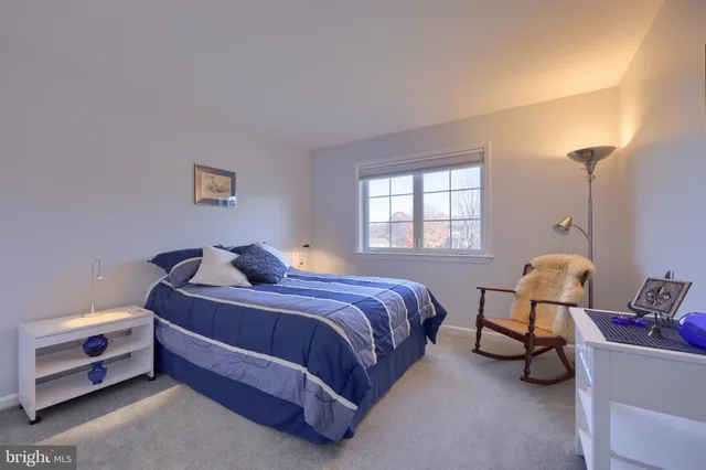 a bedroom with a bed and painting on the wall