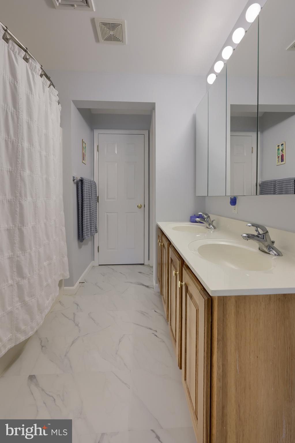 728 Skywalk Lane Lancaster, PA 17601 - Photo 31 of 39 a bathroom with a sink and mirror