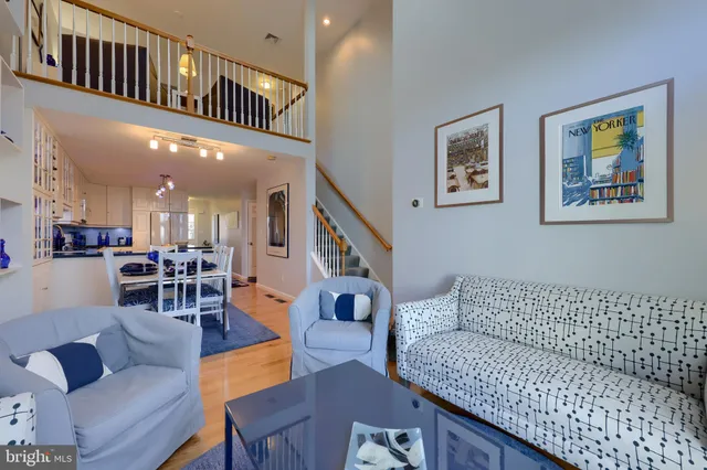 a living room with furniture and a dining table