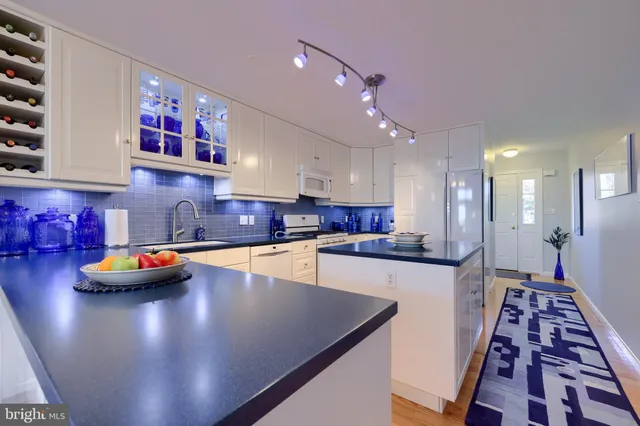 a kitchen with stainless steel appliances dining table and chairs