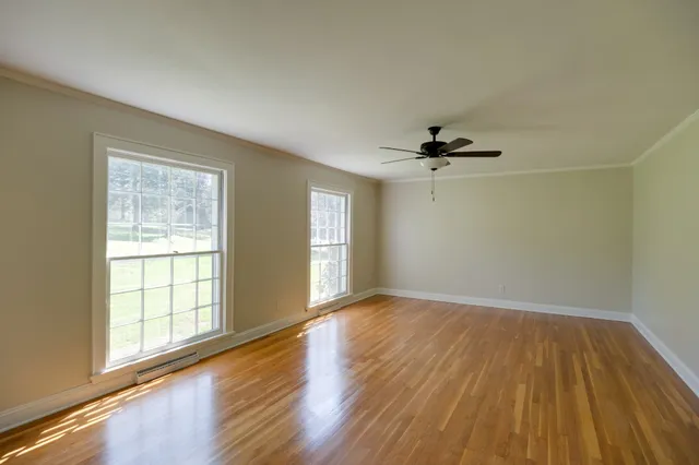a kitchen with granite countertop a sink cabinets and wooden floor