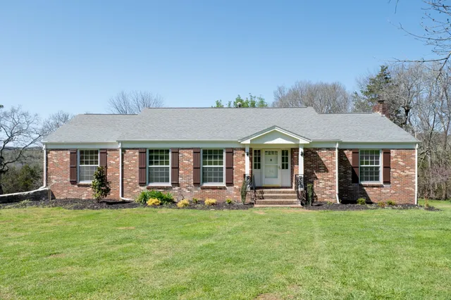front view of a house with a yard table and chairs