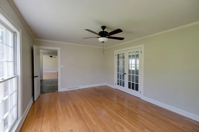 a view of a hallway with wooden floor