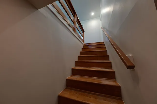 a view of an empty room with a fireplace and a window