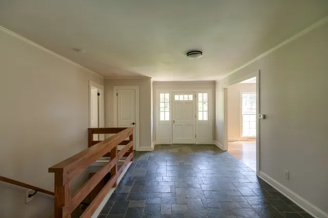 an empty room with windows and entrance
