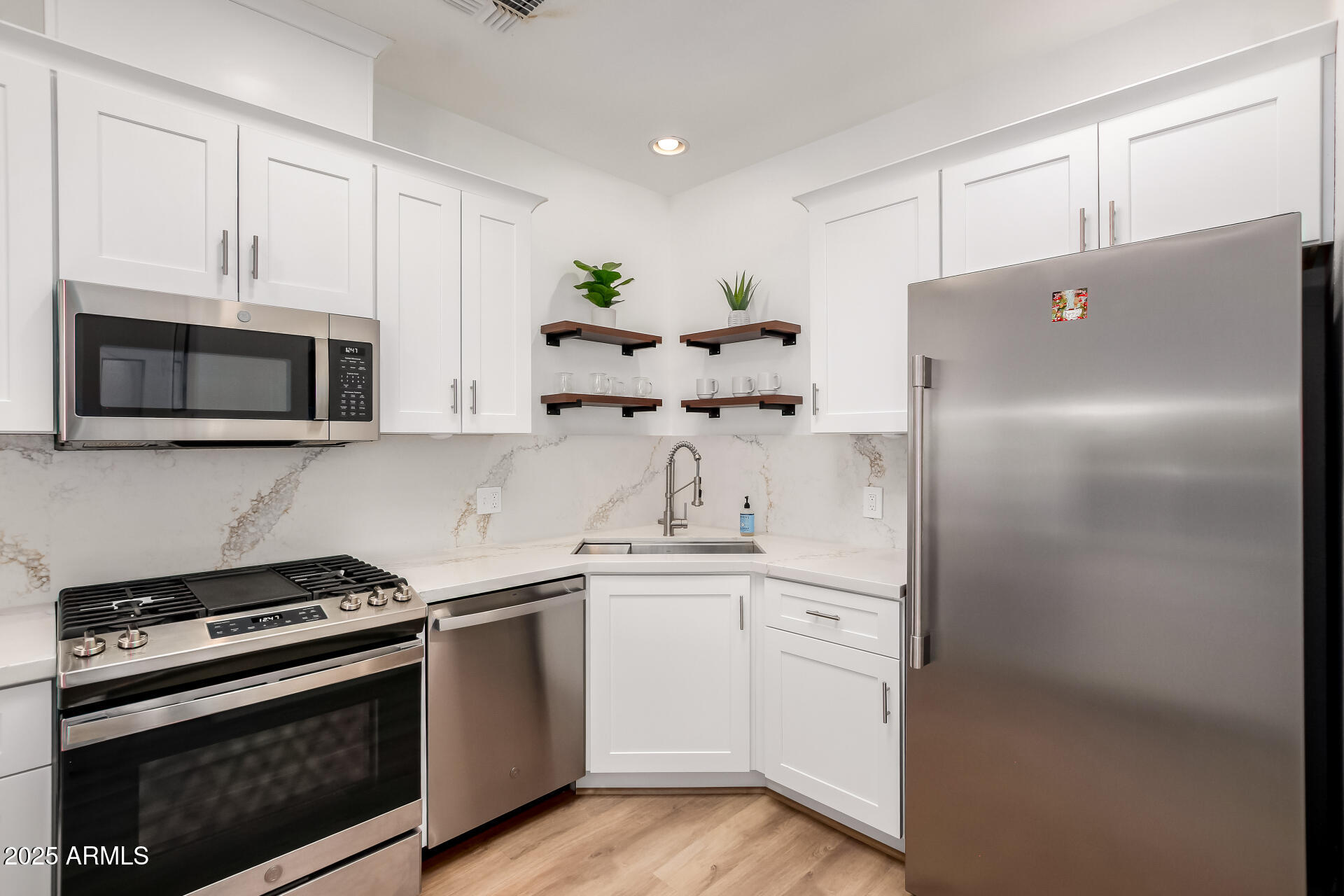 3221 North 37th Street, Unit 4 Phoenix, AZ 85018 - Photo 12 of 40 a kitchen with stainless steel appliances white cabinets and a stove