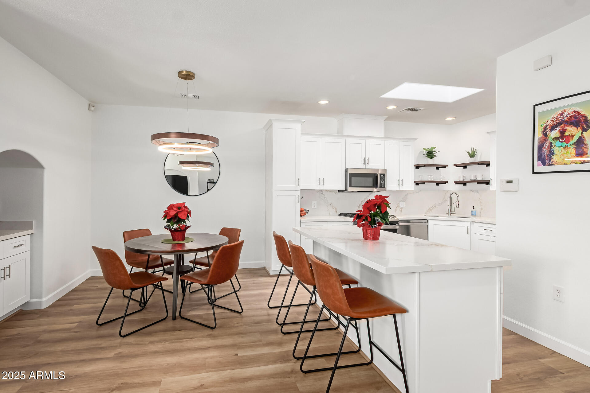 3221 North 37th Street, Unit 4 Phoenix, AZ 85018 - Photo 15 of 40 a room with stainless steel appliances kitchen island granite countertop a dining table chairs and a refrigerator