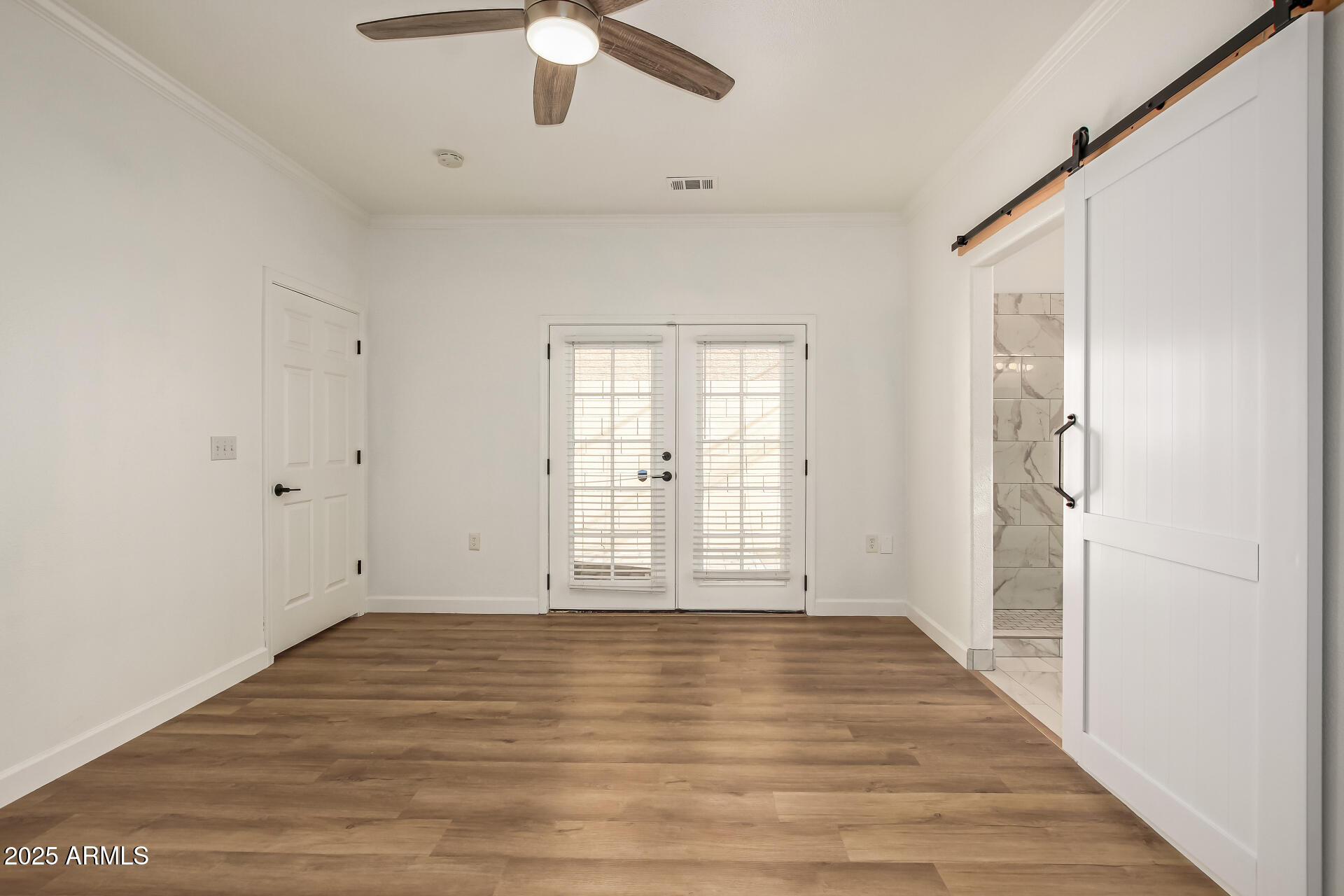 3221 North 37th Street, Unit 4 Phoenix, AZ 85018 - Photo 20 of 40 a view of an empty room with wooden floor and a window