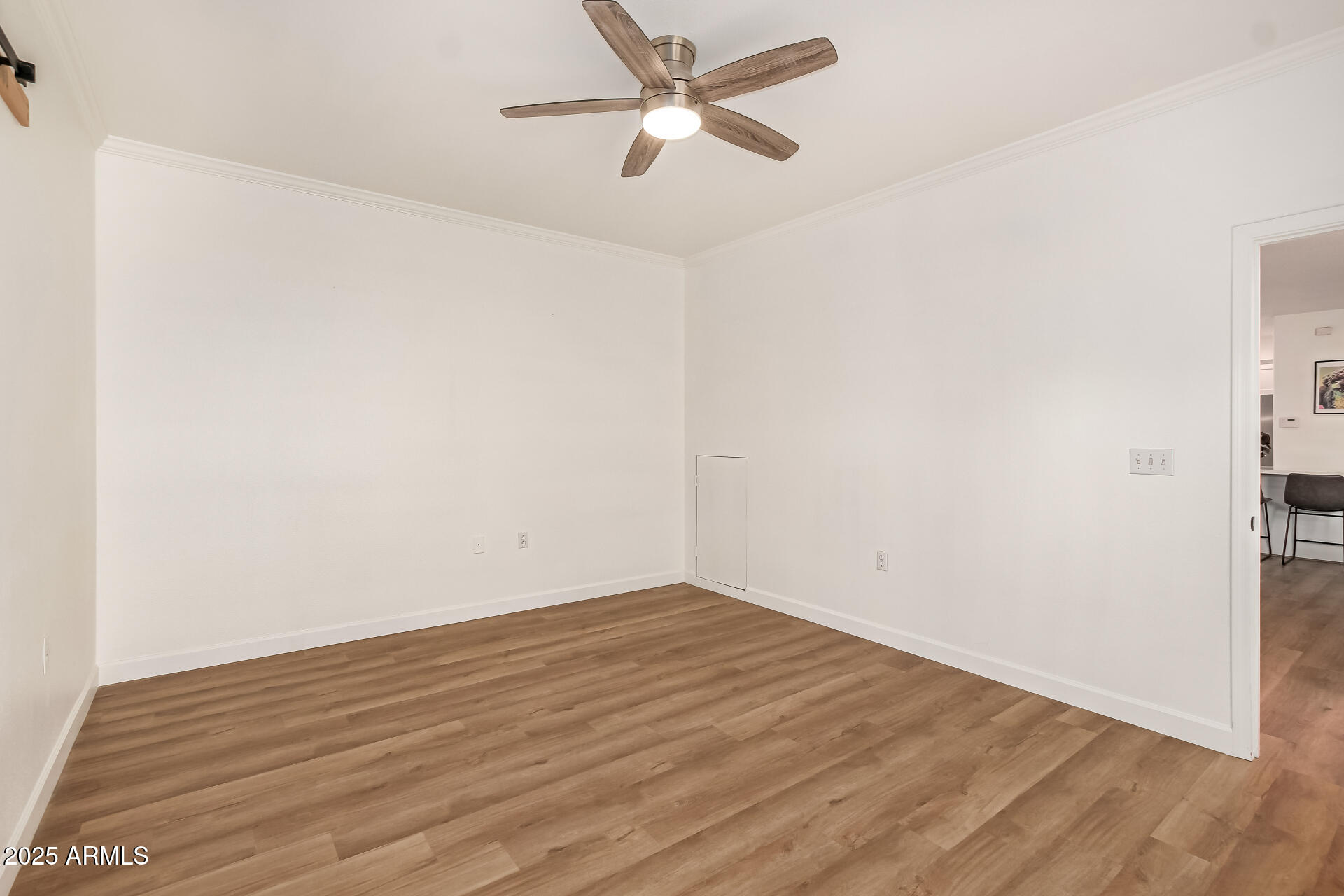 3221 North 37th Street, Unit 4 Phoenix, AZ 85018 - Photo 22 of 40 an empty room with wooden floor and a ceiling fan