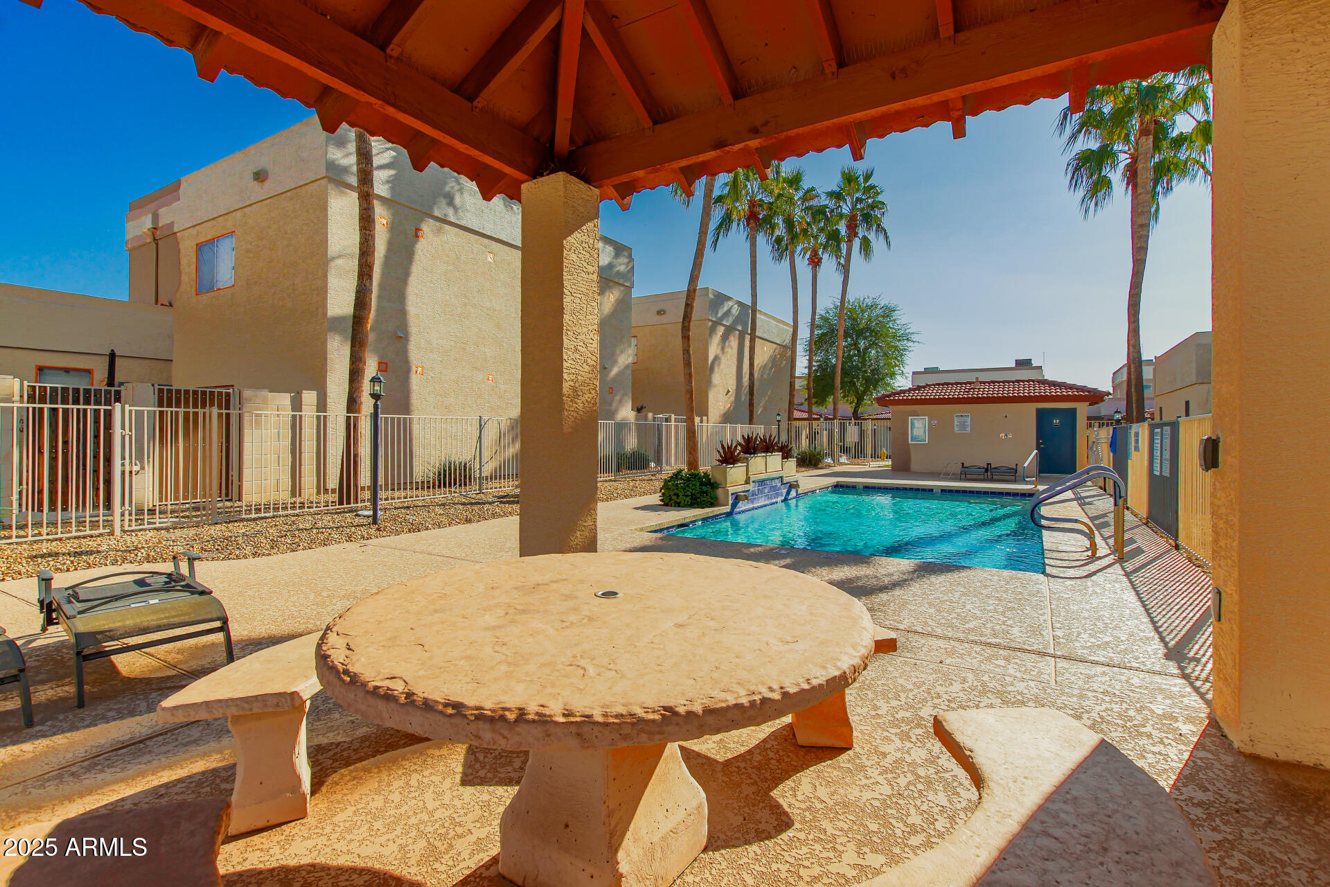3221 North 37th Street, Unit 4 Phoenix, AZ 85018 - Photo 39 of 40 a view of a patio with table and chairs under an umbrella