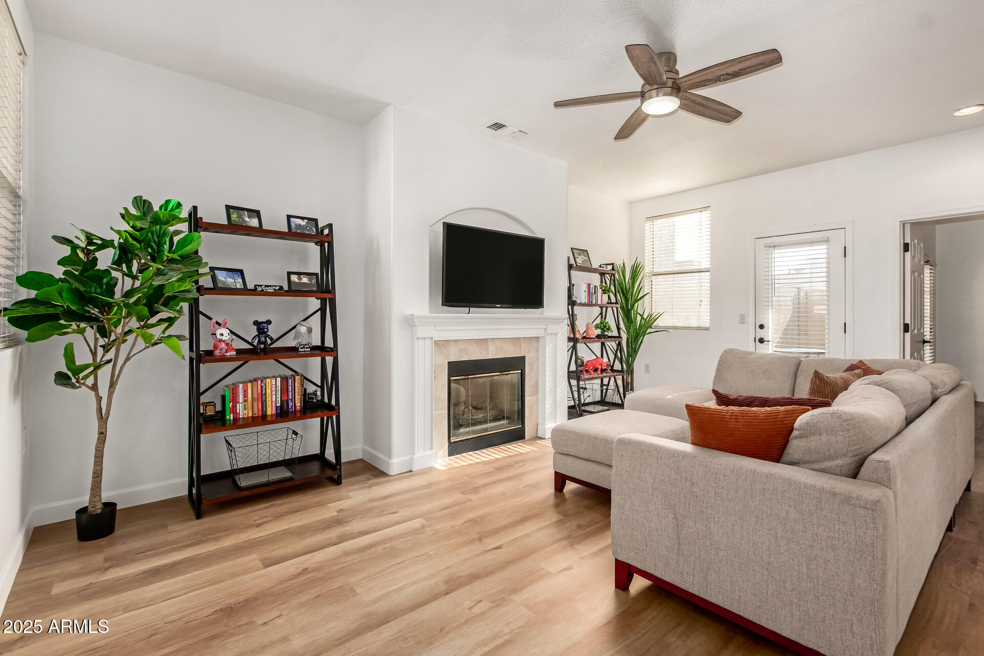 3221 North 37th Street, Unit 4 Phoenix, AZ 85018 - Photo 5 of 40 a living room with furniture a fireplace and a flat screen tv