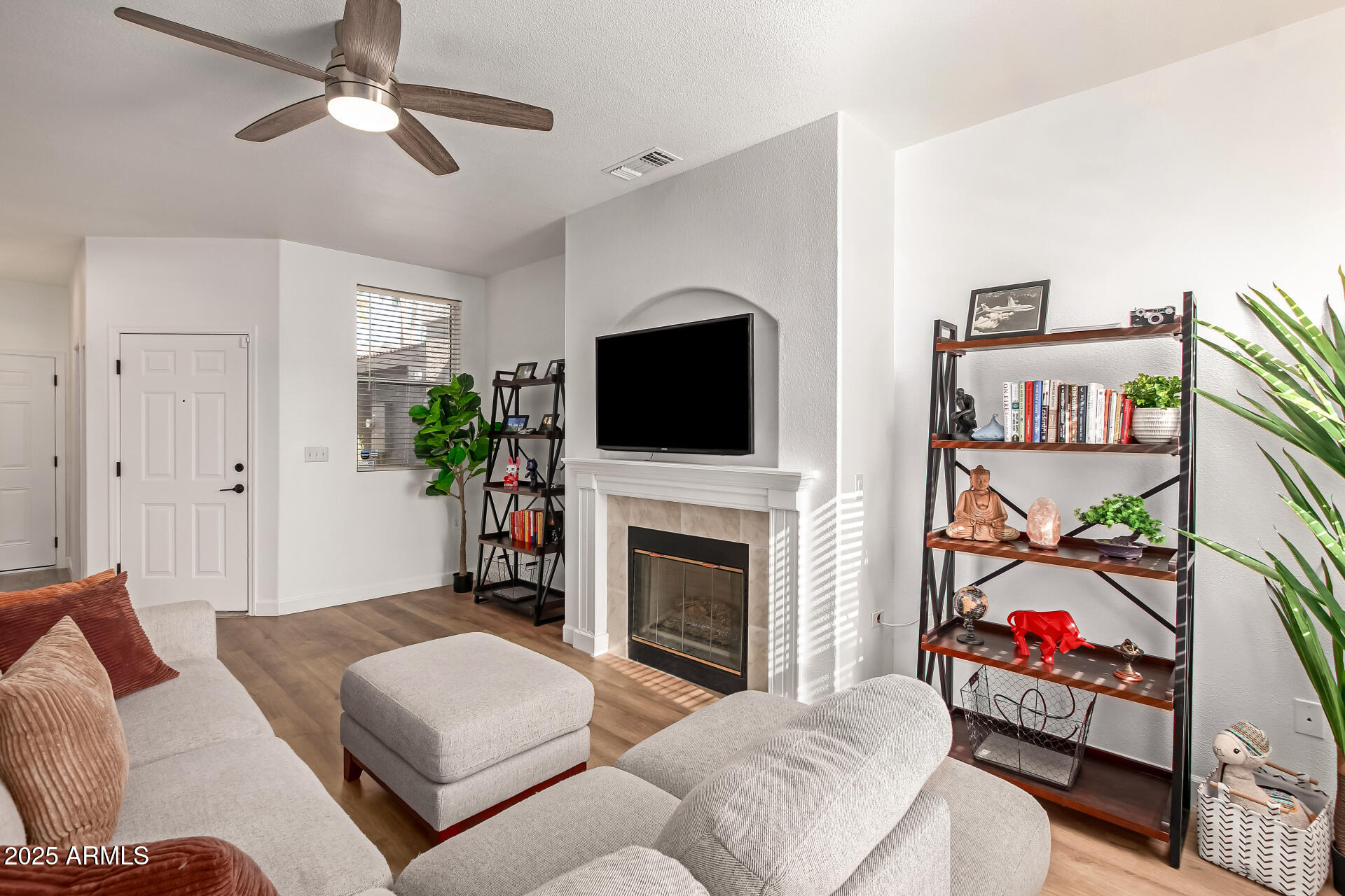 3221 North 37th Street, Unit 4 Phoenix, AZ 85018 - Photo 10 of 40 a living room with furniture a flat screen tv and a fireplace