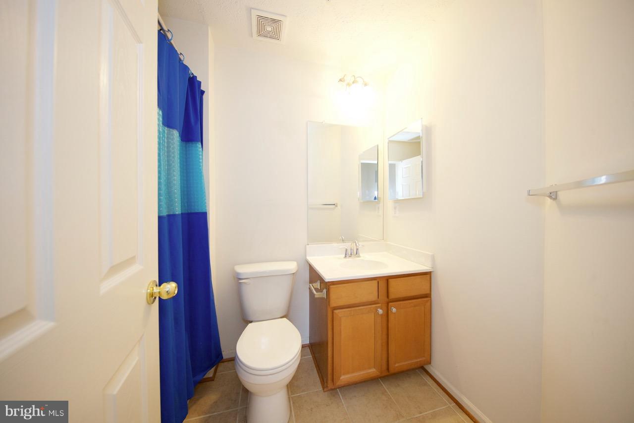 9878 Decatur Road Baltimore, MD 21220 - Photo 22 of 30 a bathroom with a toilet sink and mirror
