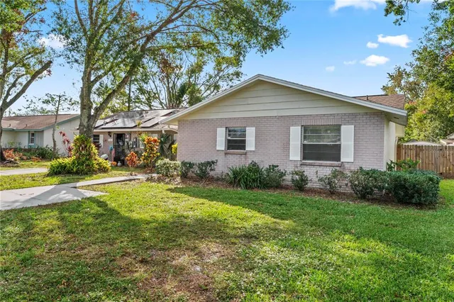 a view of backyard of house with green space