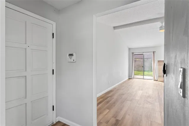 a view of a room with wooden floor