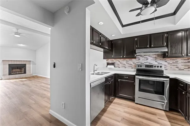 a kitchen with stainless steel appliances granite countertop a stove sink and cabinets