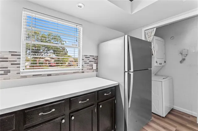 a kitchen with a refrigerator and a sink
