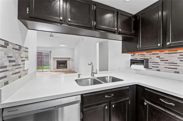 a kitchen with stainless steel appliances a sink stove and cabinets
