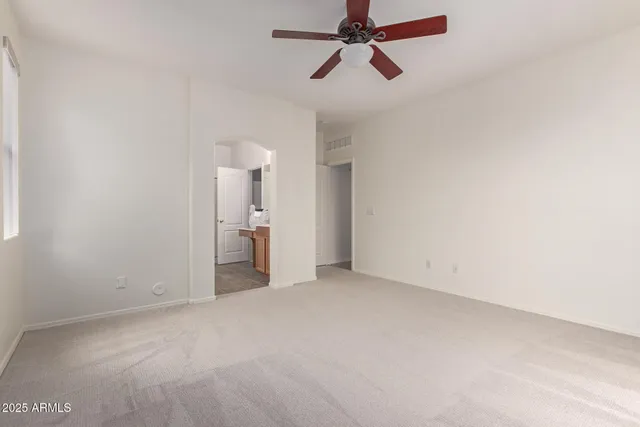 a view of empty room with ceiling fan