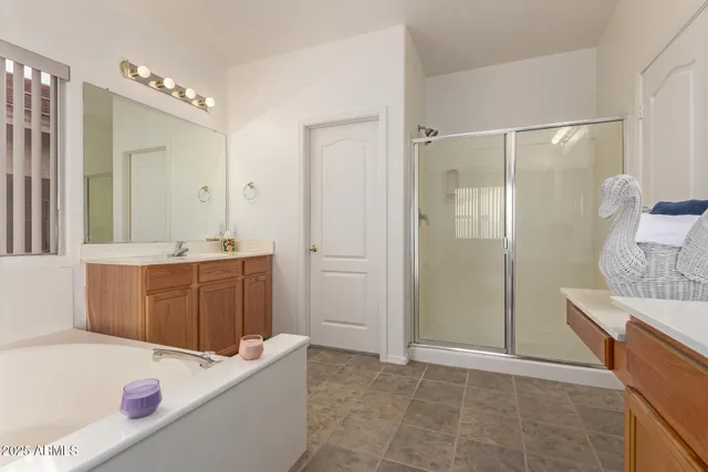 a bathroom with a tub sink and mirror