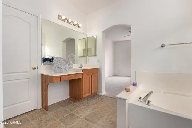 a bathroom with a bathtub sink and mirror
