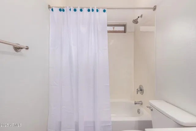 a bathroom with a shower curtain and a bath tub