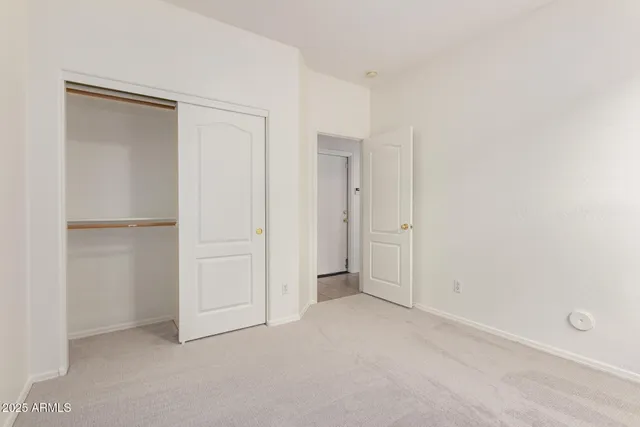 an empty room with closet area