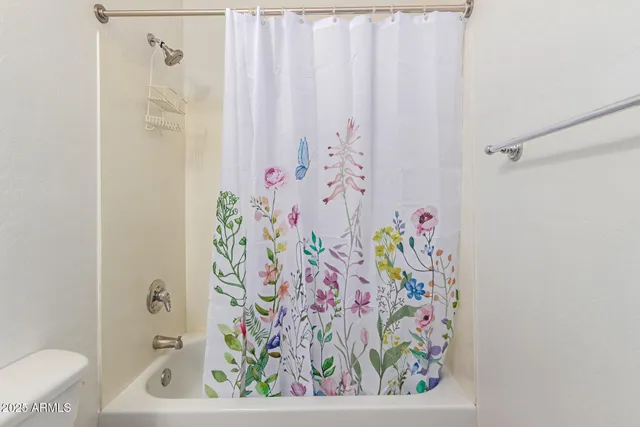 a bathroom with a bathtub and shower curtain