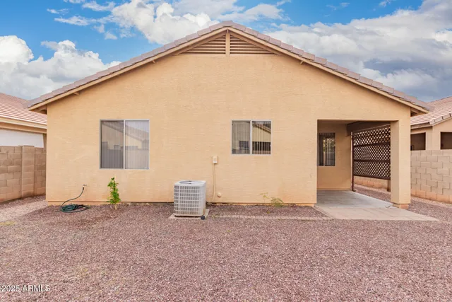 a view of house with backyard and trees